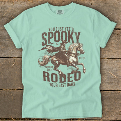 T-shirt with "Spooky Rodeo" graphic featuring a witch on horseback.