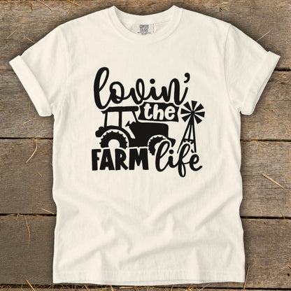 White t-shirt with black graphic "Lovin' the Farm Life" and tractor.