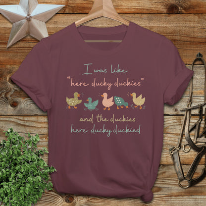 Maroon t-shirt with text "I was like 'here ducky duckies' and the duckies here ducky duckied"