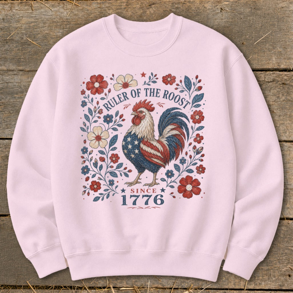 Pink sweatshirt with a patriotic rooster and floral design, reading "Ruler of the Roost Since 1776".
