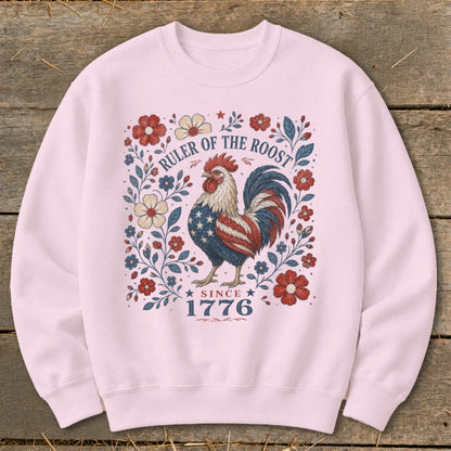 Pink sweatshirt with a patriotic rooster and floral design, reading "Ruler of the Roost Since 1776".