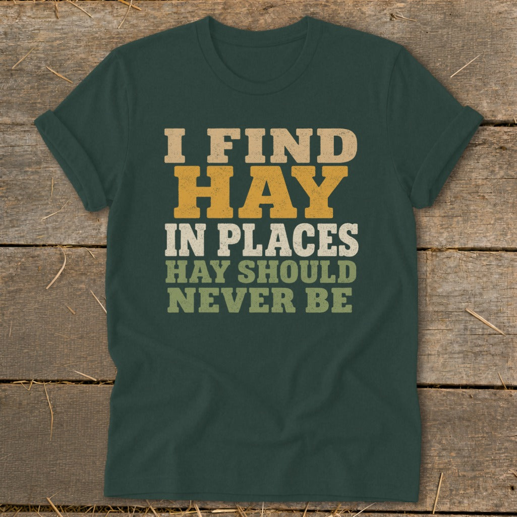 Dark green t-shirt with text "I FIND HAY IN PLACES HAY SHOULD NEVER BE".