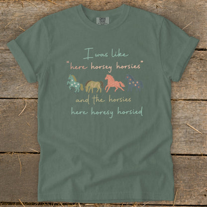 Green t-shirt with text and four illustrated horses: "I was like 'here horsey horsies' and the horsies here horesy horsied."