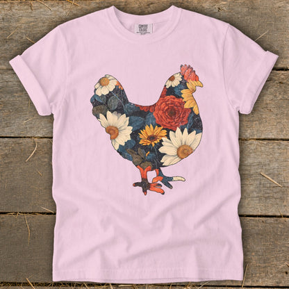 Pink t-shirt with a chicken silhouette filled with colorful flowers.