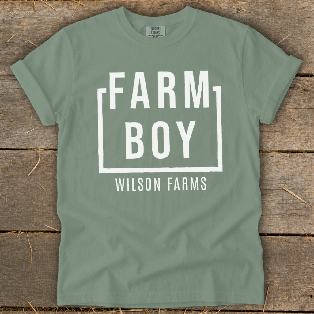 Green t-shirt with white text "FARM BOY WILSON FARMS" in a box.