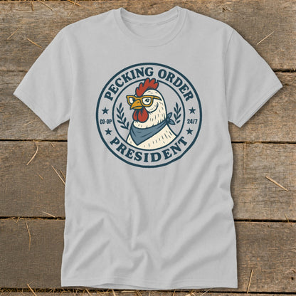 Chicken wearing glasses and bandana on gray t-shirt, text reads "Pecking Order President".