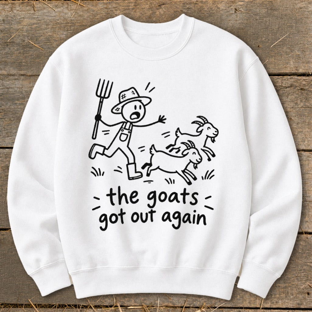 White sweatshirt with black illustration of farmer chasing goats with text "the goats got out again".
