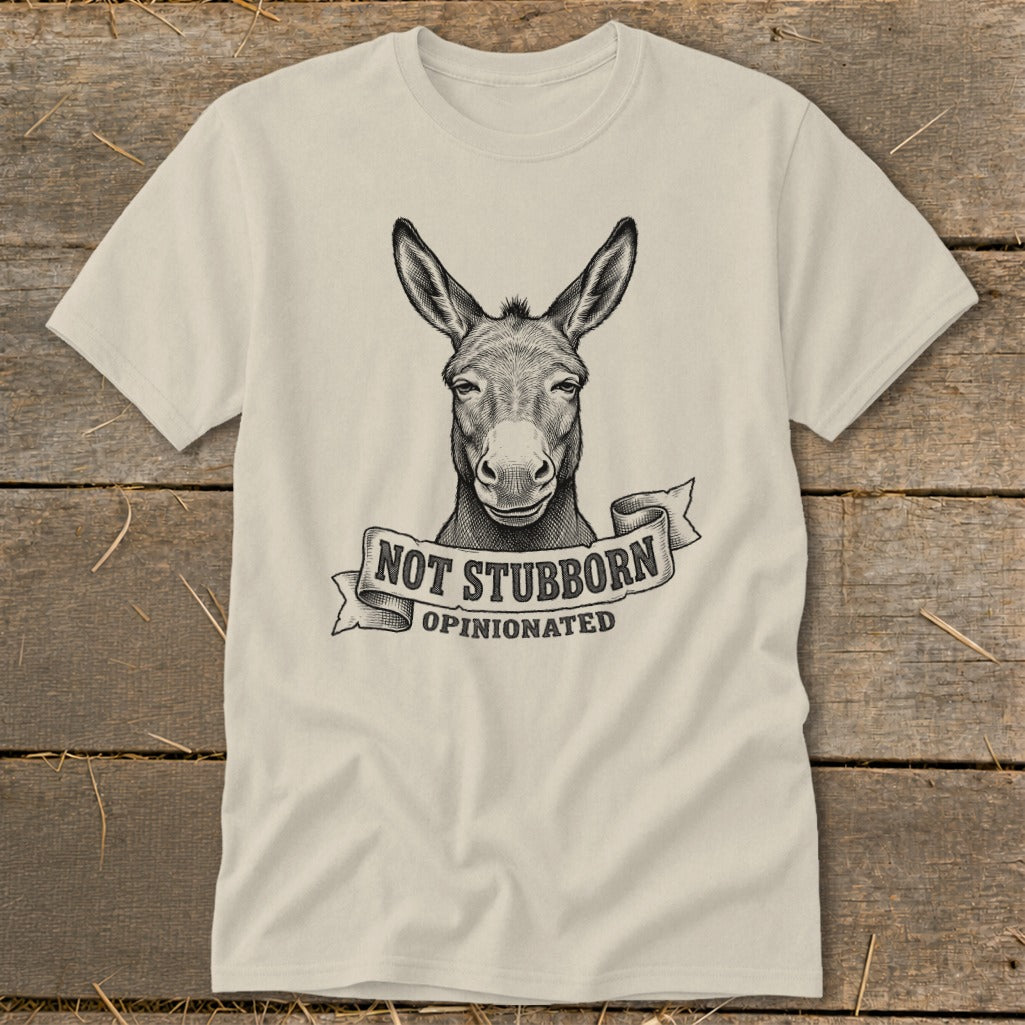 Cream t-shirt with a donkey illustration and the text "NOT STUBBORN OPINIONATED".