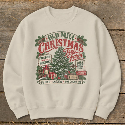 Cream sweatshirt with "Old Mill Christmas Tree Farm" graphic featuring a tree, lantern, gifts, and holiday text.