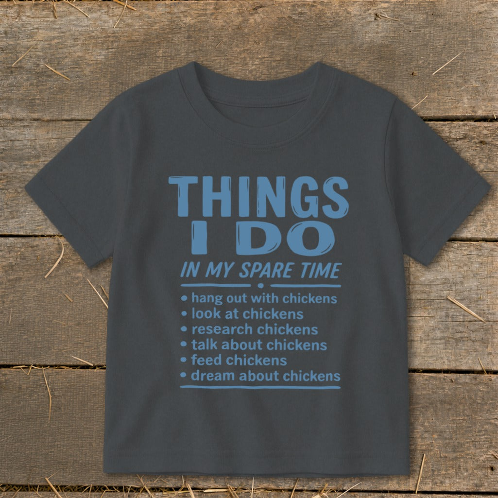 Dark gray t-shirt with blue text listing chicken-related activities.