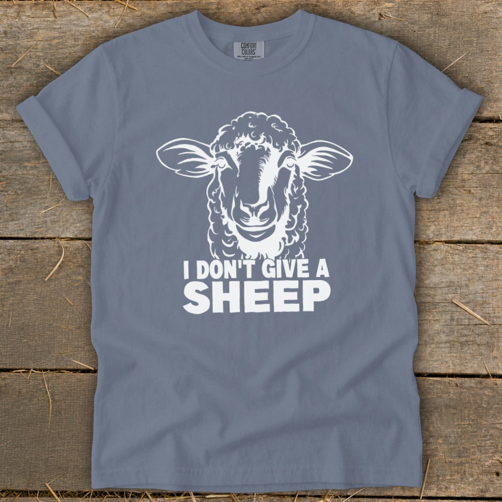 Blue t-shirt with white graphic of sheep head and text "I DON'T GIVE A SHEEP".