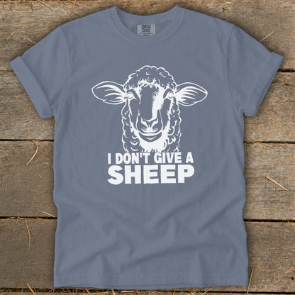 Blue t-shirt with white graphic of sheep head and text "I DON'T GIVE A SHEEP".