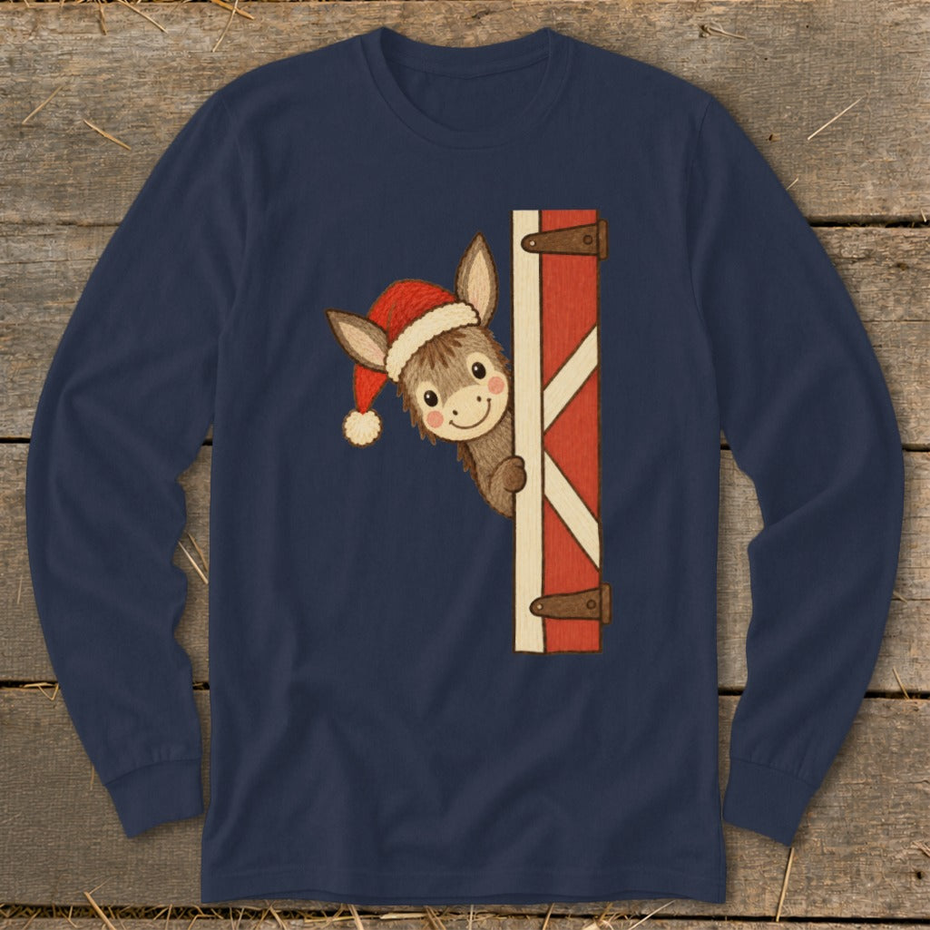 Donkey wearing Santa hat peeks around barn door on navy long-sleeve shirt.