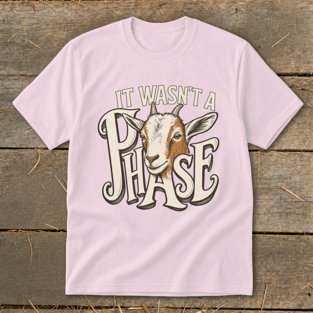 Pink t-shirt with a goat graphic and text "IT WASN'T A PHASE".