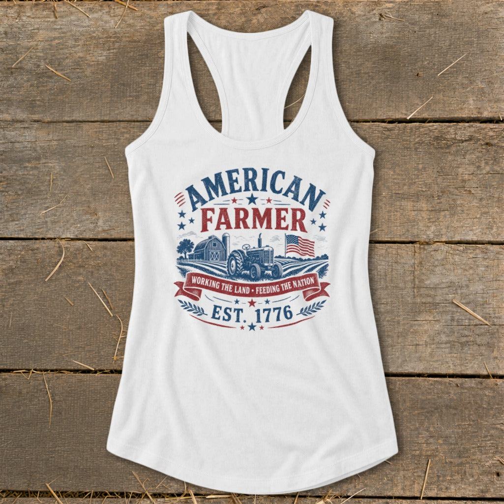 White tank top with "American Farmer" graphic featuring tractor, barn, flag, and "Est. 1776".