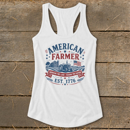 White tank top with "American Farmer" graphic featuring tractor, barn, flag, and "Est. 1776".