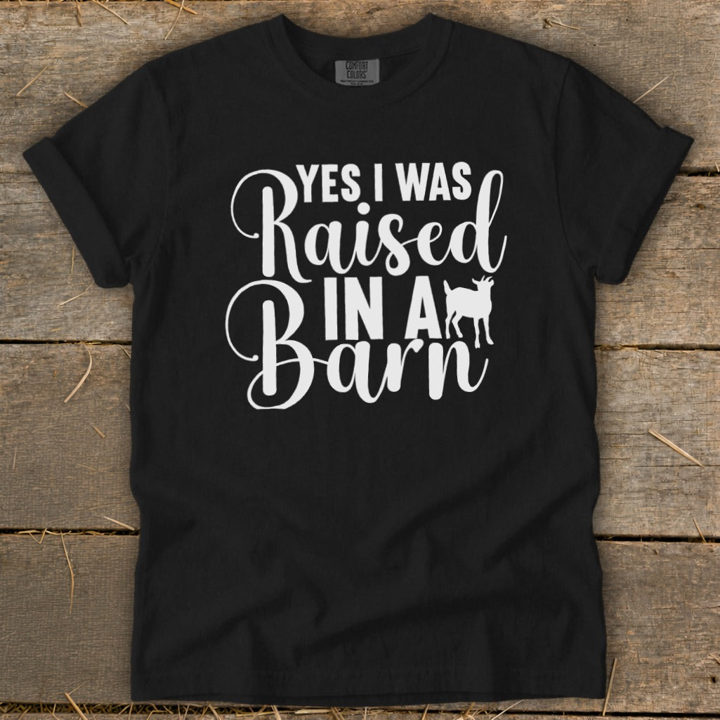 Black t-shirt with white text "Yes I Was Raised In A Barn" and a goat silhouette.