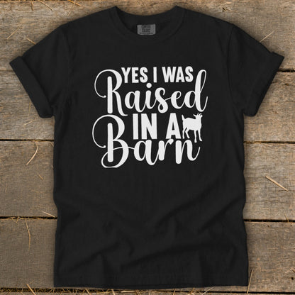 Black t-shirt with white text "Yes I Was Raised In A Barn" and a goat silhouette.
