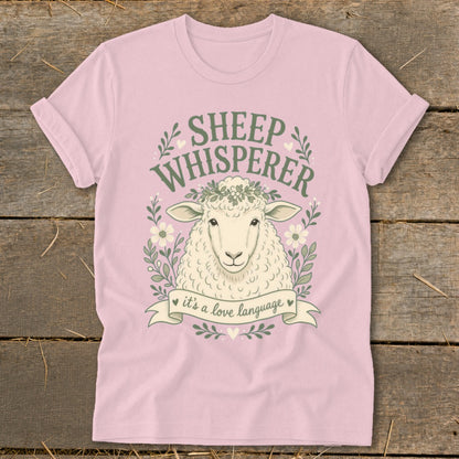 Pink t-shirt with sheep illustration and "Sheep Whisperer" text.