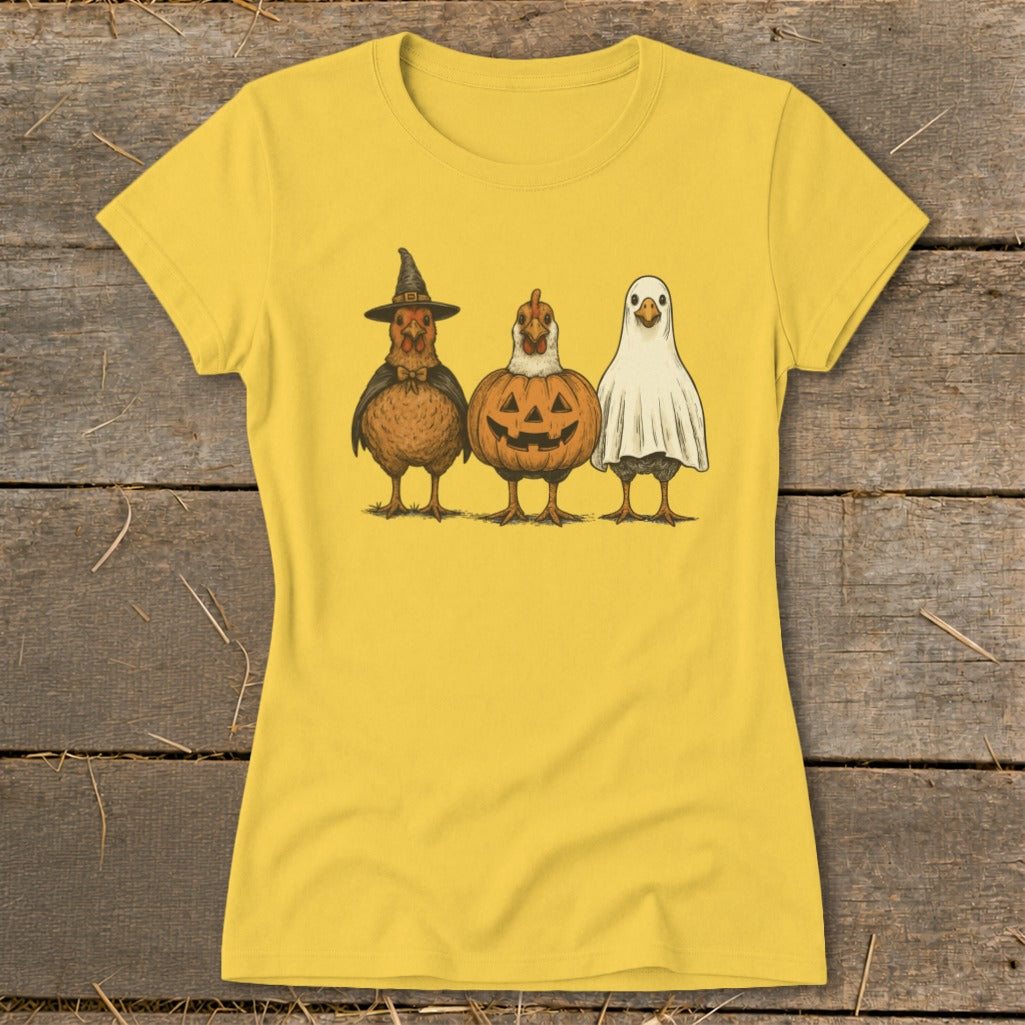 Three chickens in Halloween costumes: witch, jack-o'-lantern, and ghost.