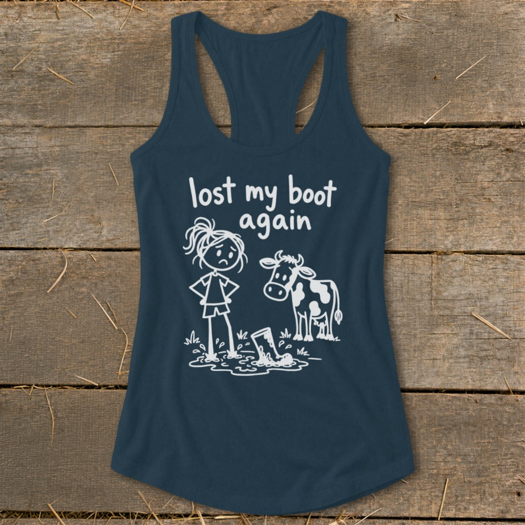 Dark blue racerback tank top featuring a white graphic of a cow and a girl looking at a muddy boot, with text reading "lost my boot again."