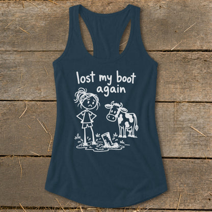 Dark blue racerback tank top featuring a white graphic of a cow and a girl looking at a muddy boot, with text reading "lost my boot again."