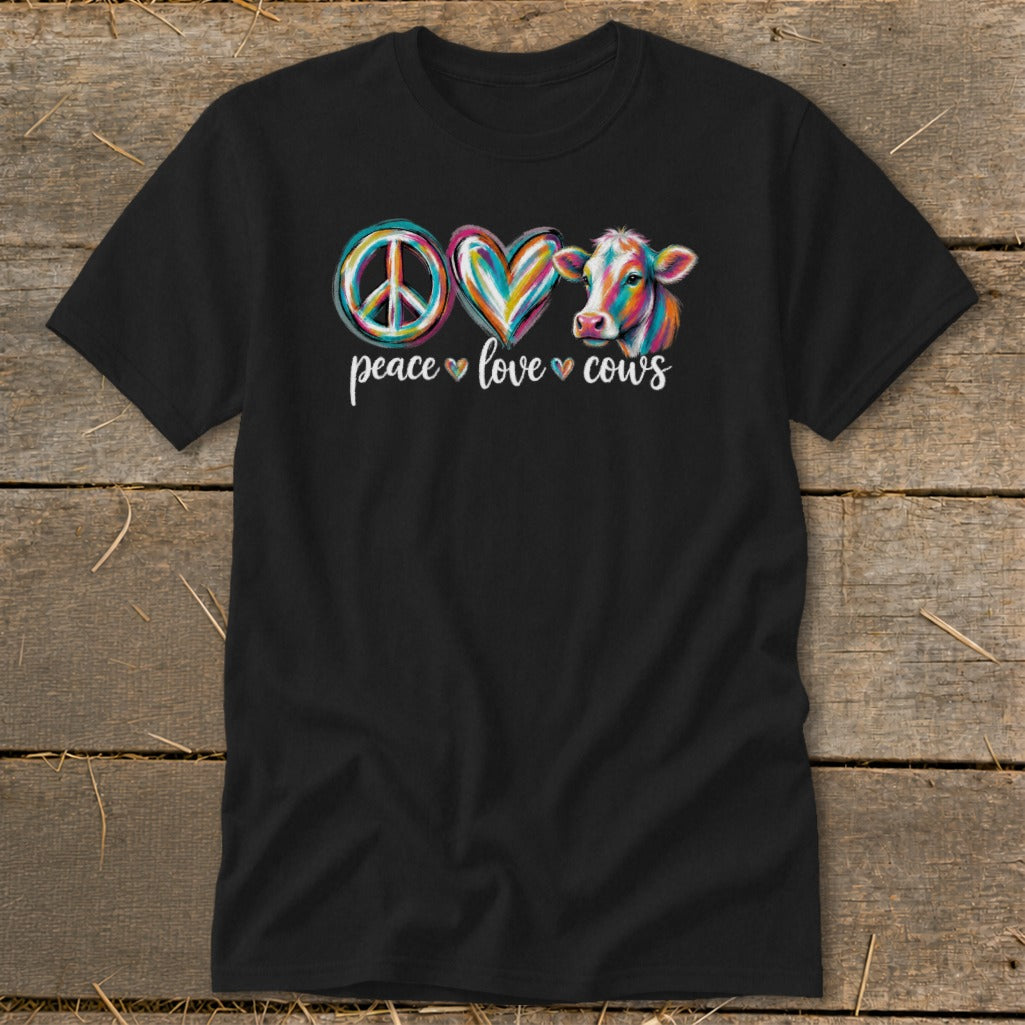 Black t-shirt with a peace sign, heart, and colorful cow design, reading "peace love cows".