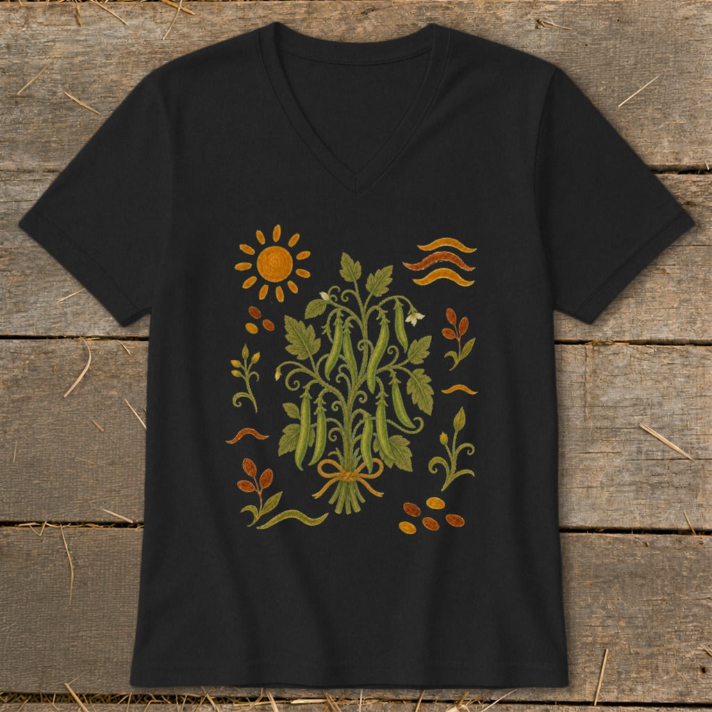 Black t-shirt with a central bouquet of green pea pods and surrounding whimsical garden elements.