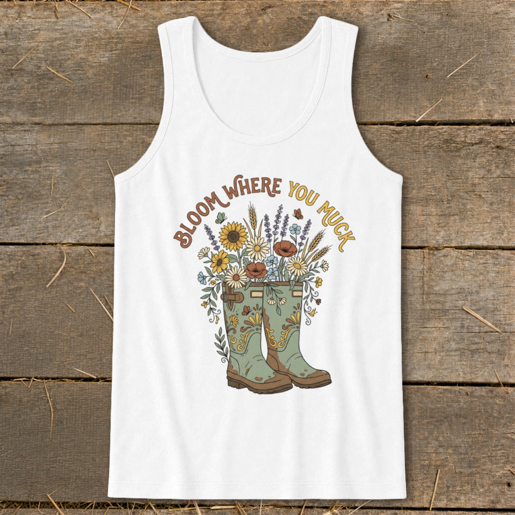 White tank top with green boots, flowers, and text "BLOOM WHERE YOU MUCK".