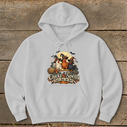 Light grey hoodie with Halloween graphic of three chickens in witch hats on a broom.