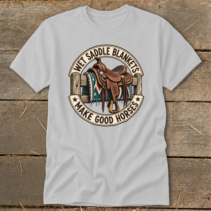 T-shirt with graphic of a saddle and blanket on a fence, reading "Wet Saddle Blankets Make Good Horses."