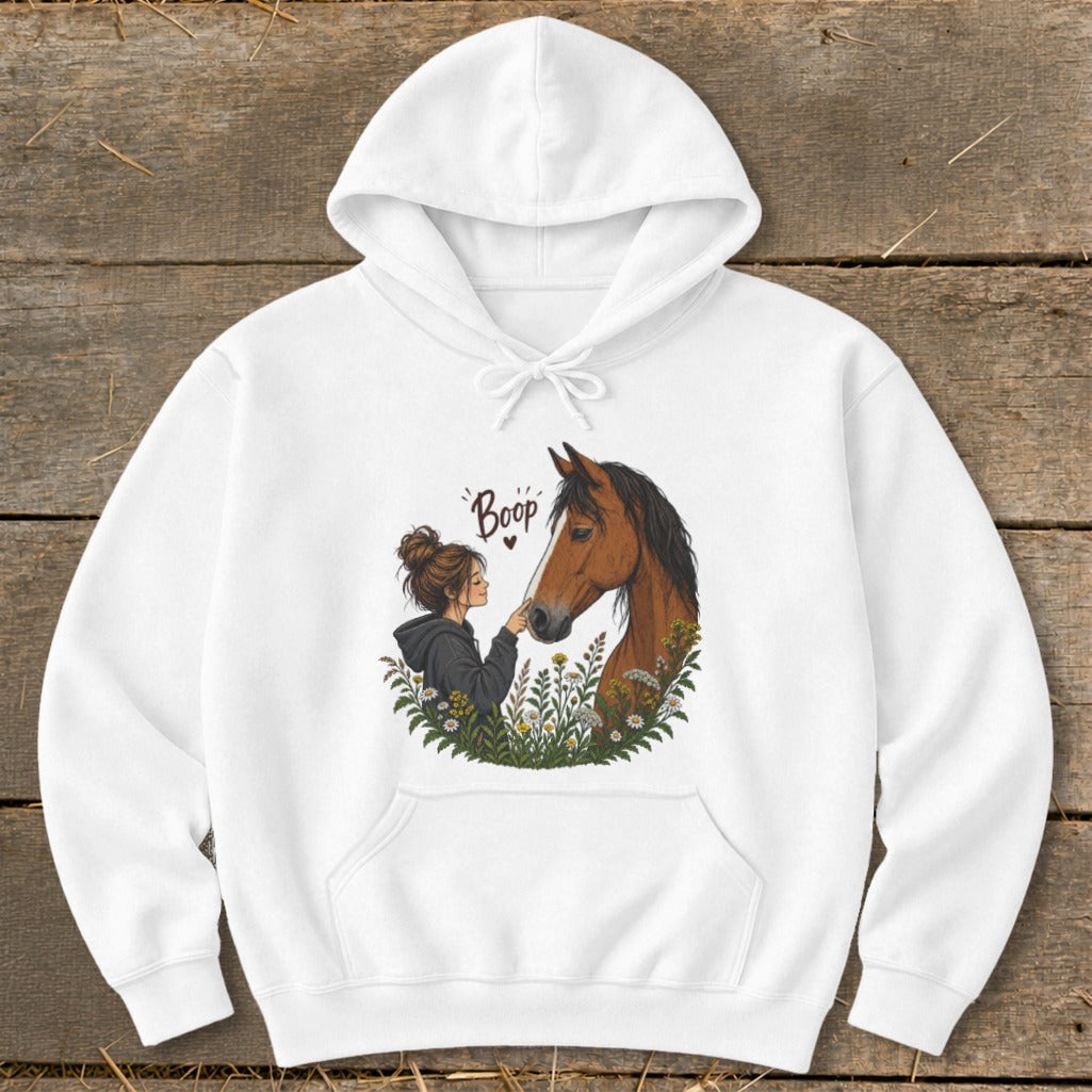 White hoodie with illustration of girl and horse in flowers, reading "Boop".