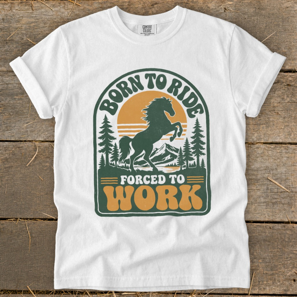 White t-shirt with a retro graphic of a horse ready to buck, text reads "Born to Ride" and "Forced to Work".