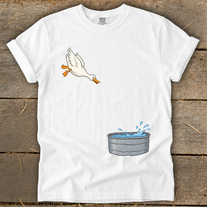 White t-shirt with cartoon goose jumping into a galvanized tub of water.