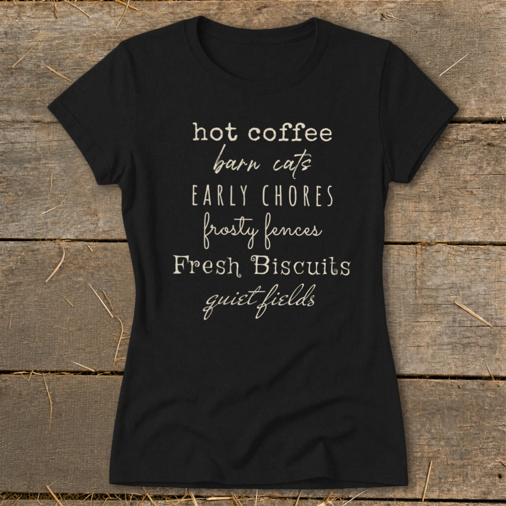 Black t-shirt with text: hot coffee, barn cats, early chores, frosty fences, fresh biscuits, quiet fields.