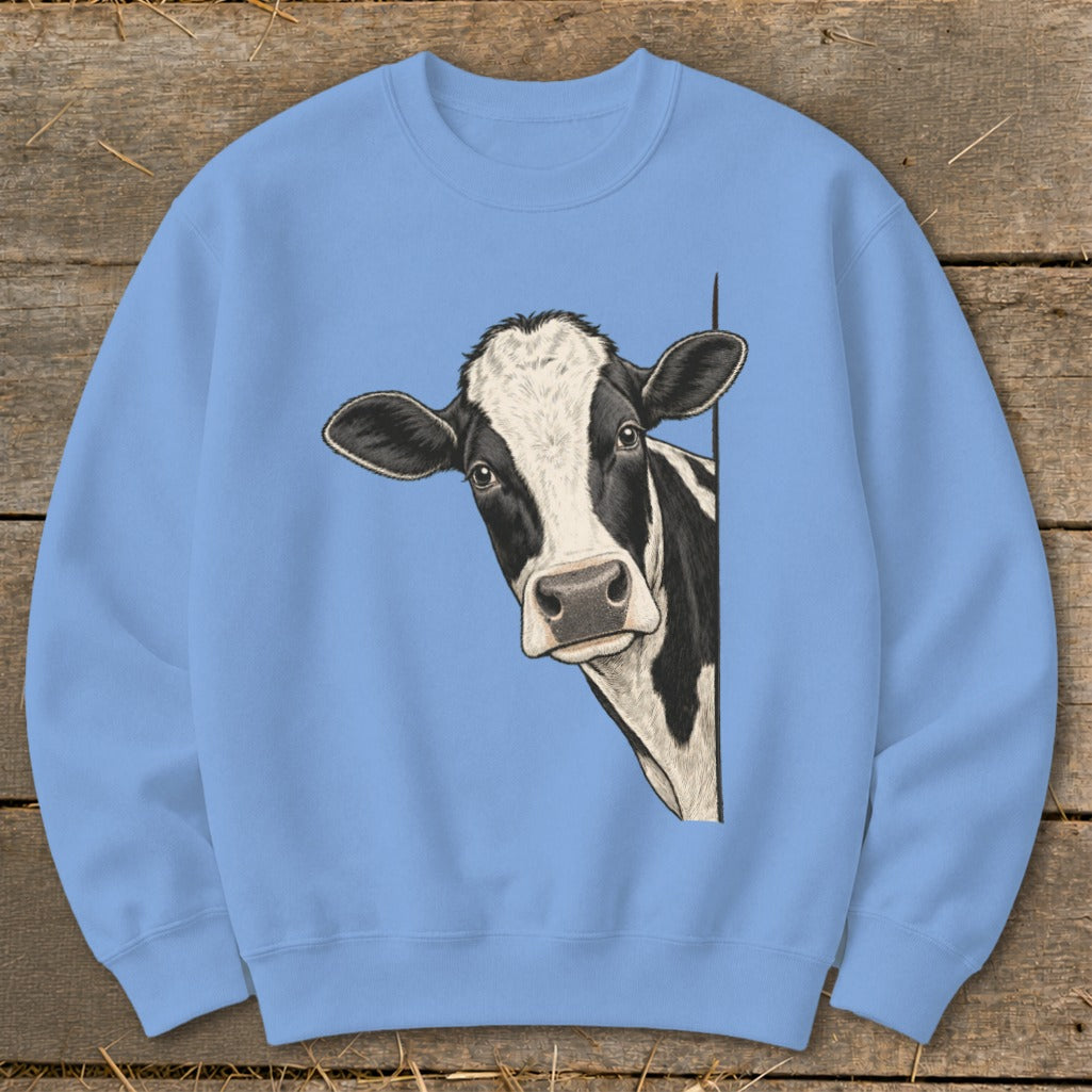 Light blue sweatshirt with a black and white cow peeking around the side.