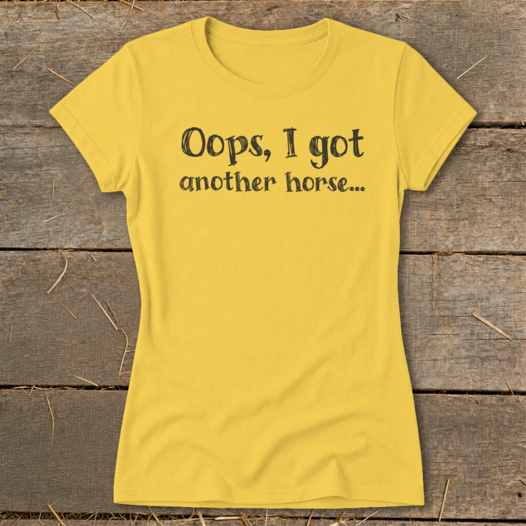 Yellow t-shirt with black text "Oops, I got another horse..."
