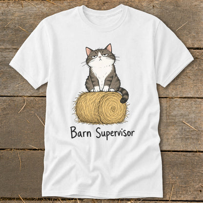 White t-shirt with cartoon cat sitting on hay bale, text "Barn Supervisor".