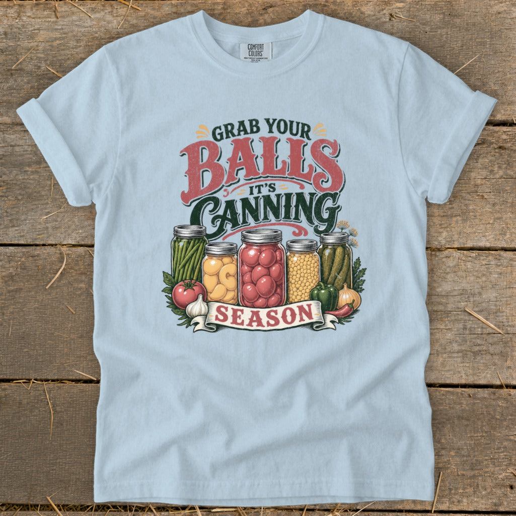 T-shirt graphic with jars of canned food and text that says "Grab Your Balls It's Canning Season".