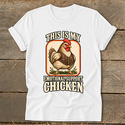 White t-shirt graphic with text "This is my Emotional Support Chicken" and illustration.