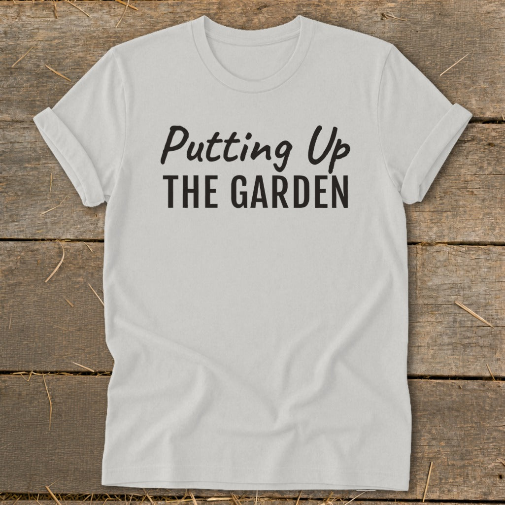 White t-shirt with "Putting Up THE GARDEN" text in black lettering.