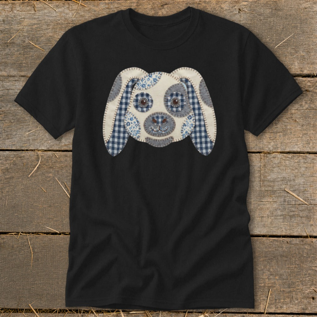 Black t-shirt with a fabric applique of a dog's face.