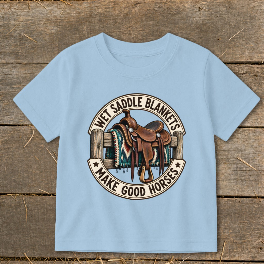 Light blue t-shirt with a graphic of a saddle, blanket, and fence with text.
