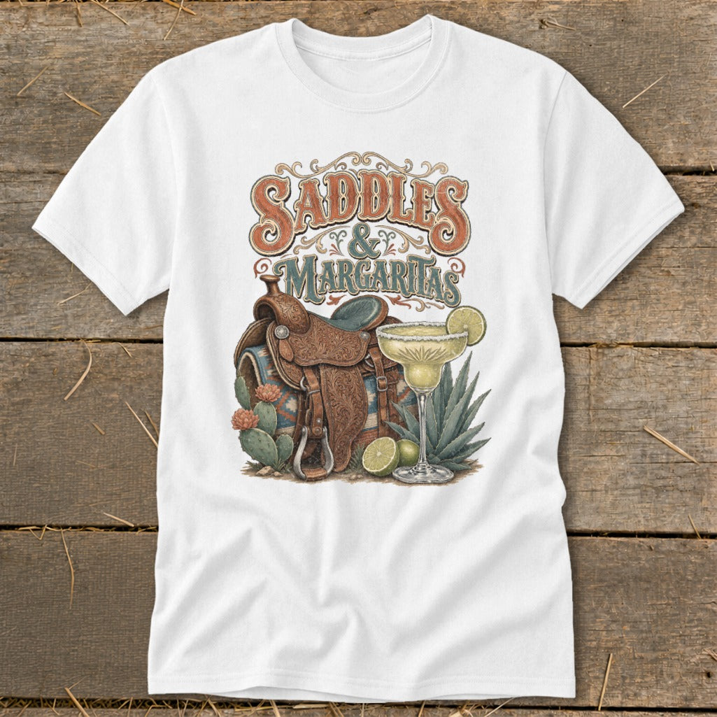 White t-shirt with "Saddles & Margaritas" graphic featuring a saddle, margarita, and cacti.