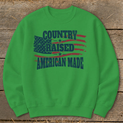 Green sweatshirt with "Country Raised American Made" and distressed American flag graphic.
