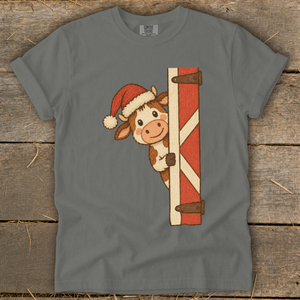 Cow wearing Santa hat peeking from behind barn door with "COMFORT COLORS" tag.
