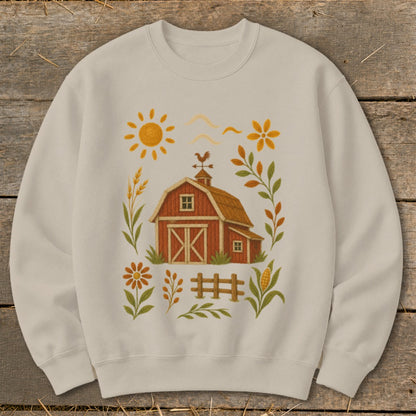 Cream sweatshirt with a red barn and farm scene graphic design.