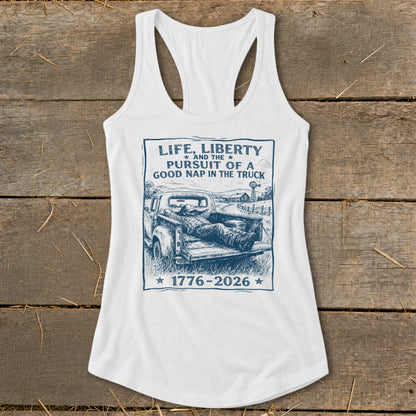 White tank top with "Life, Liberty, and the Pursuit of a Good Nap in the Truck" graphic.
