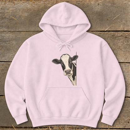 Pink hoodie with a black and white cow peeking from the side.