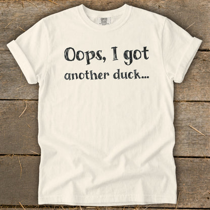 Cream t-shirt with black text that says "Oops, I got another duck..."